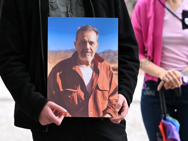 A demonstrator holds a picture of Iranian-German Jamshid Sharmahd, who has been sentenced