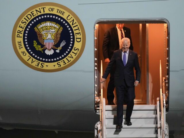 President Joe Biden walks down the stairs of Air Force One as he arrives at Brandenburg Ai