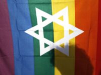 FILE - In this file photo taken on June 25, 2009, an Israeli man walks behind a pride flag