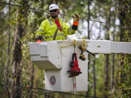 Workers attempt to restore power lines after Hurricane Helene made landfall in Keaton Beac