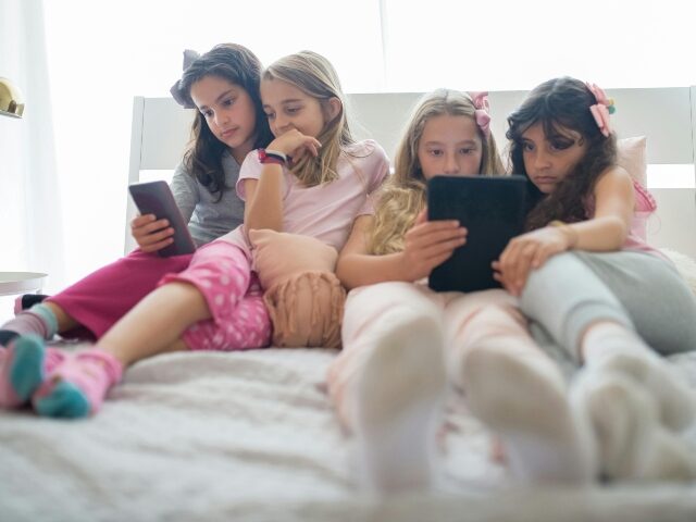 Little girls looking at TikTok on devices