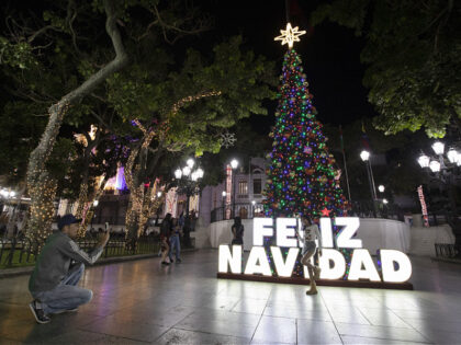 CARACAS, VENEZUELA - OCTOBER 2: A woman takes a photo in front of Christmas decorations at