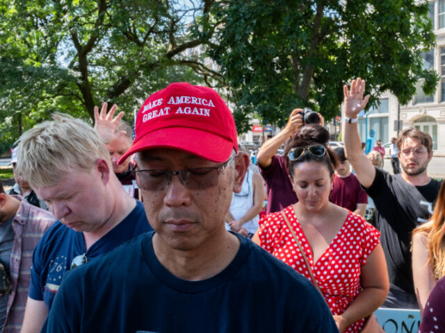 A group of Trump supporters pray for former President Donald Trump in Zeidler Union Square