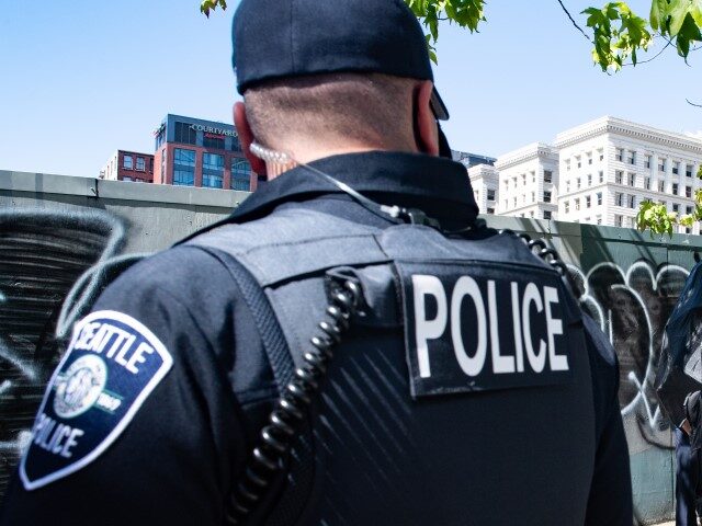 A counter protester yells a Seattle Police officer during the Seattle Police Officers Guil