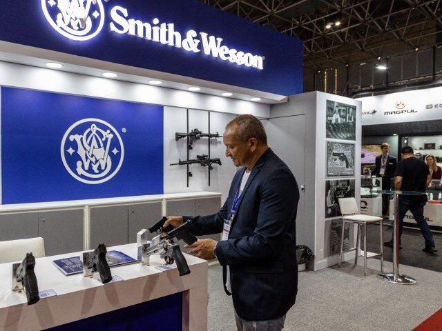 An attendee views guns on display at the Smith & Wesson booth during the Latin America