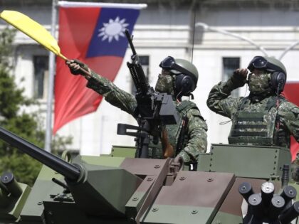 In this Oct. 10, 2021, file photo, Taiwanese soldiers salute during National Day celebrati