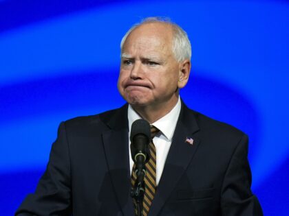 Democratic vice presidential nominee Minnesota Gov. Tim Walz reacts as he speaks at the Am