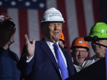 Republican presidential nominee former President Donald Trump stands on stage with steelwo