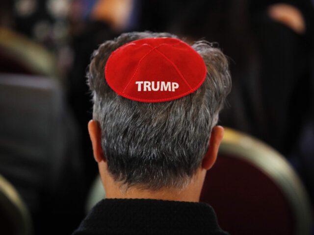 An attendee wears a yarmulke with the word "Trump" before President Donald Trump