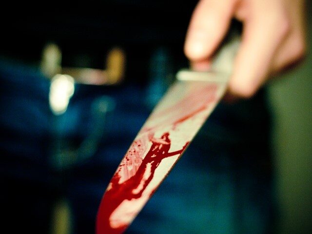 bloody knife in man's hand