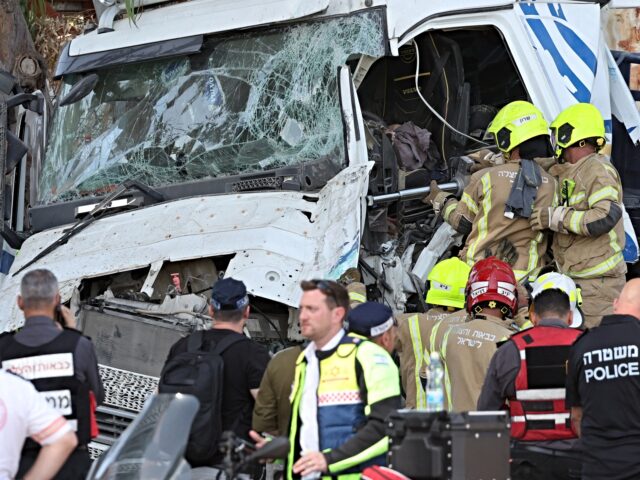 Israeli police and emergency responders recover the body of the truck driver at the site o