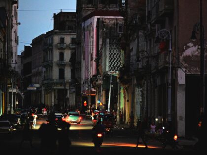 A street is lit by car lights during the third night of a nationwide blackout in Havana Oc