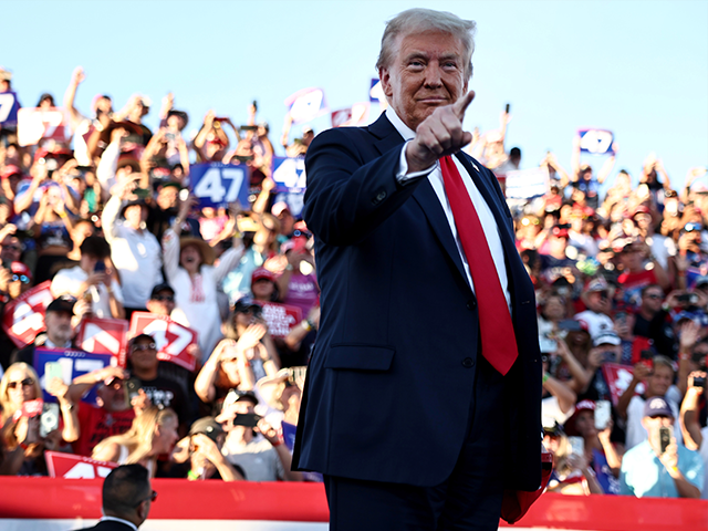 former U.S. President Donald Trump points as he walks onstage for a campaign rally on Octo