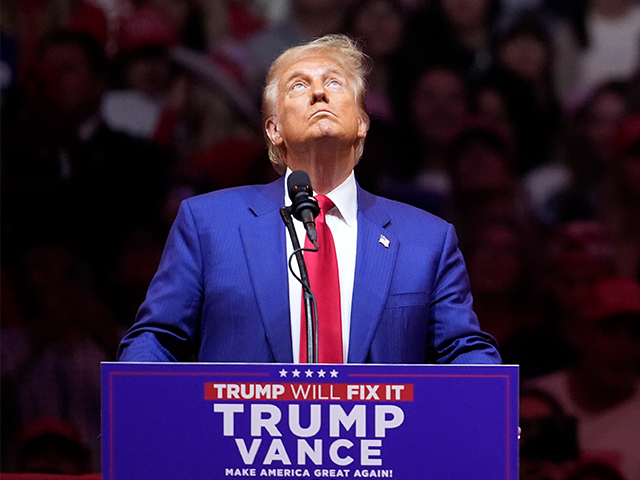 Former President Donald Trump looks up at a video as he speaks at a campaign rally at Madi