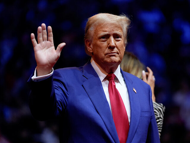 Republican presidential nominee former President Donald Trump waves to the crowd while on