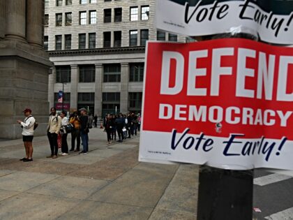 Philadelphia residents wait in a line around city hall to cast their ballot on the last da