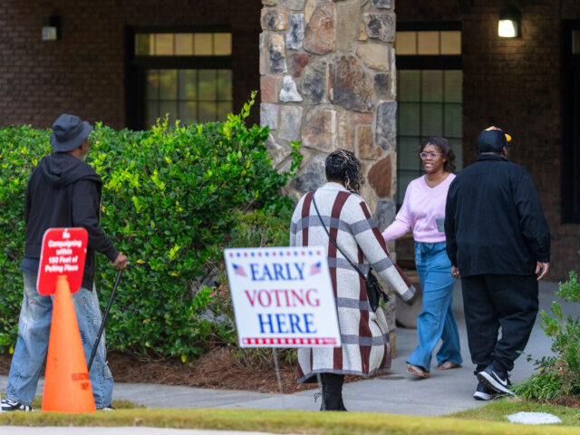 Voters are seen entering and exiting the polling station, Thursday, Oct. 31, 2024, in Stoc