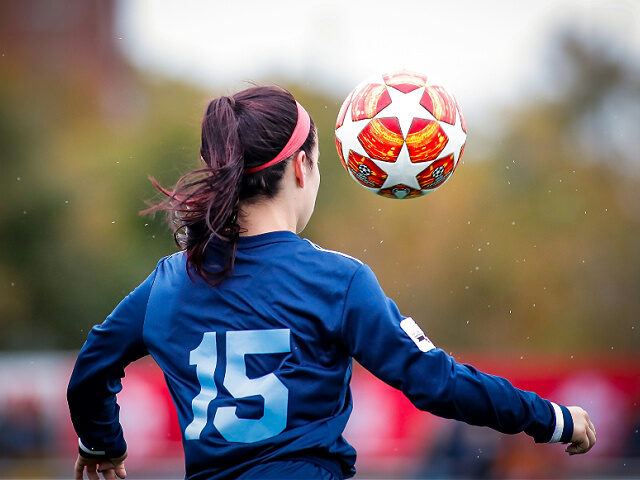 girl in blue and white nike soccer jersey shirt