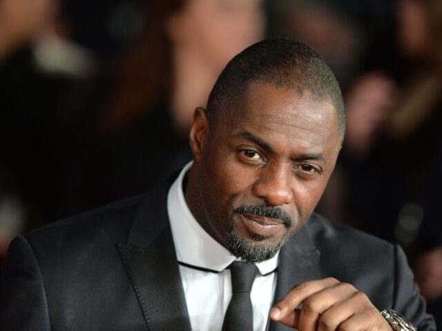 English actor Idris Elba, who plays the role of Nelson Mandela, poses on the red carpet up