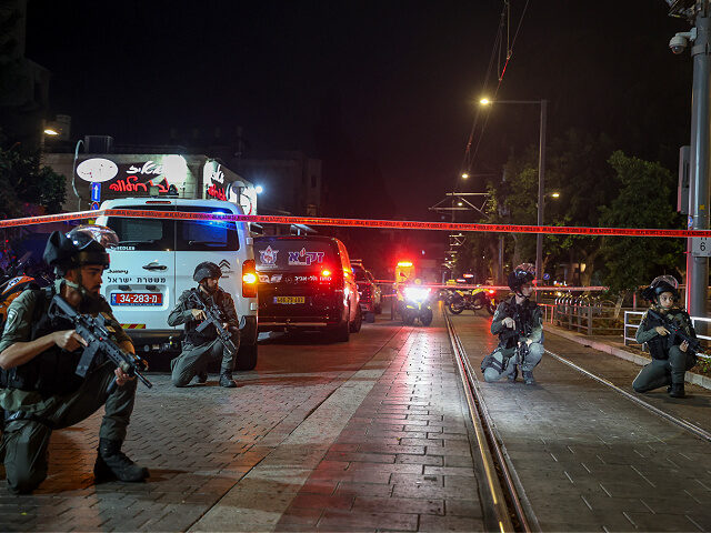 Israeli policemen take position after a shooting attack in Jaffa, a mixed Arab-Jewish area