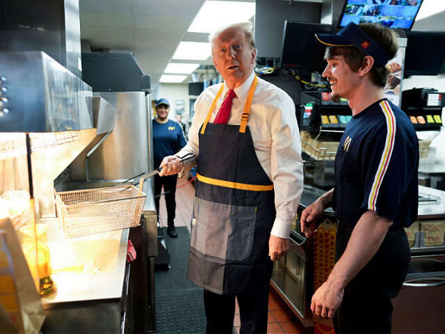 Republican presidential nominee former President Donald Trump works behind the counter dur