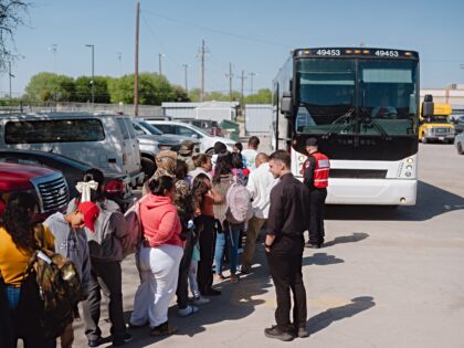 Migrants board a state-sponsored bus to New York outside the Mission: Border Hope non-prof