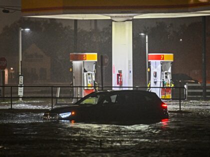 A vehicule is stranded on a water-flooded street after Hurricane Milton made landfall in B