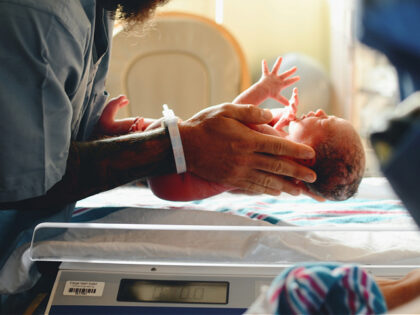 weighing a newborn baby at a hospital