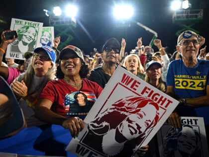 aSupporters cheer during a campaign rally with former US President Barack Obama supporting