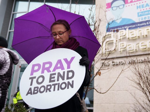 WASHINGTON, DC - JANUARY 20: Anti-abortion activists hold a moment of prayer during a prot