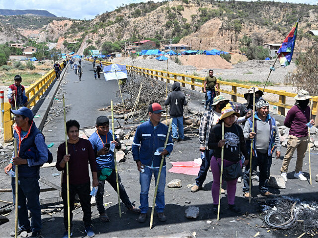 Supporters of former Bolivian President Evo Morales block a road at the entrance to the to