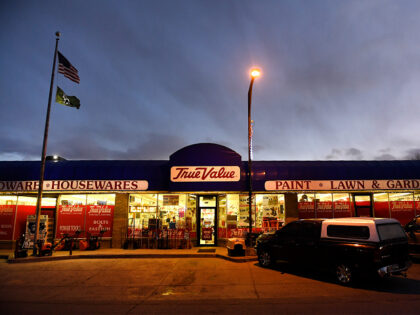 RANGELY, CO - DECEMBER 5 - The sun sets above the brightly lit True Value hardware store o