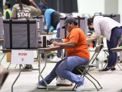 HOUSTON, TEXAS - NOVEMBER 7: Harris County election employees work as ballots arrive at NR