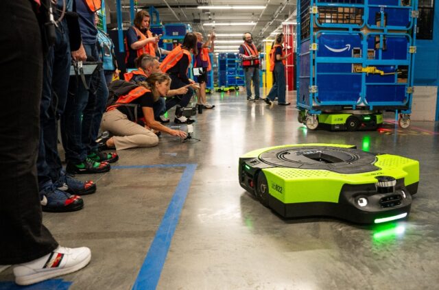 Amazon says logistics center automation, such as robots that safely maneuver loaded carts