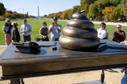 An installation depicting a pile of feces on the desk of former US speaker of the House Na