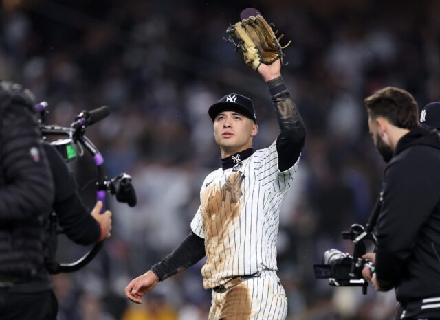 Anthony Volpe of the New York Yankees waves to the crowd of fans that was chanting his nam