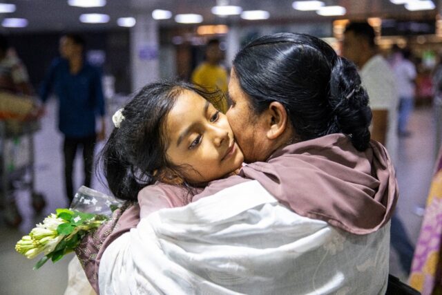 A Bangladeshi national is received by a relative upon her arrival in Dhaka from Lebanon