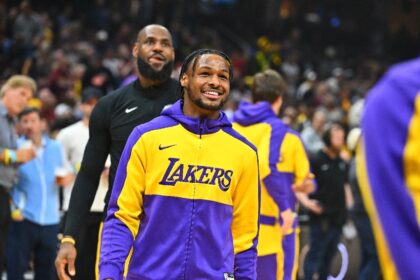 Bronny James and LeBron James of the Los Angeles Lakers warm up before an NBA game against