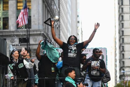 A convoy of floats and open-top buses processed up Manhattan's 'Canyon of Heroes' to City