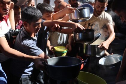 Displaced Palestinians queue to receive food rations in northern Gaza, where a blistering