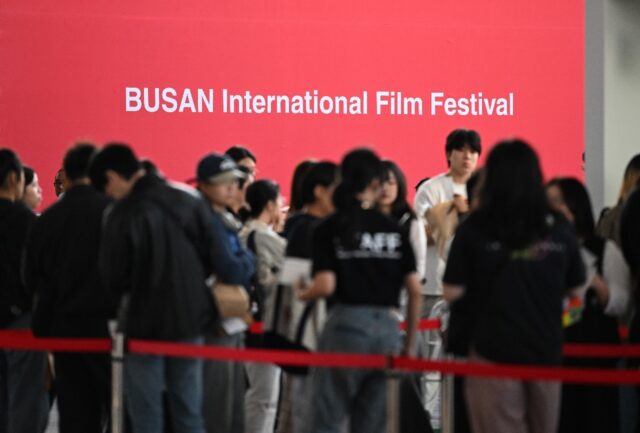 Film fans queue at a merchandise booth for the 29th Busan International Film Festival on W