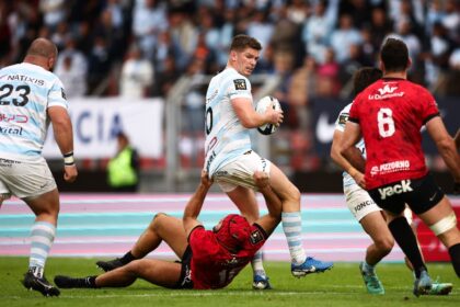 Finding his feet: Owen Farrell (C) tries to escape a tackle as his Racing 92 team beat Tou