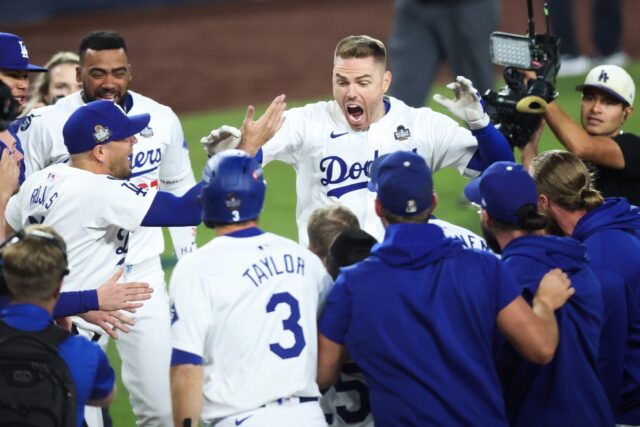 Freddie Freeman celebrates with Los Angeles Dodgers teammates after hitting a walk-off gra