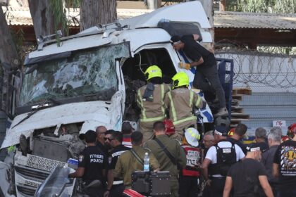 Israeli police and emergency responders recover the body of the truck driver at the site o