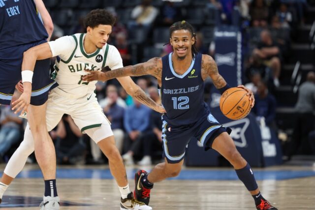 Ja Morant of the Memphis Grizzlies drives against Milwaukee's Ryan Rollins in the Grizzlie