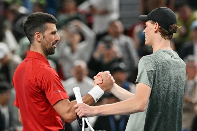 Jannik Sinner (R) is congratulated by Novak Djokovic after winning the Shanghai Masters