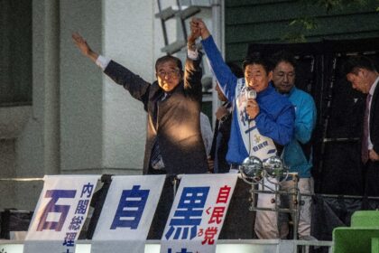 Japan's Prime Minister Shigeru Ishiba (C) arrives for a campaign speech in support of his