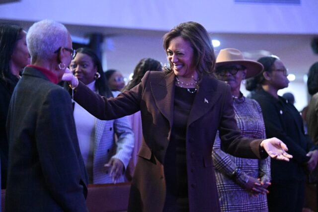 Kamala Harris greets congregants after speaking at the Church of Christian Compassion duri