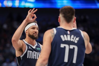 Klay Thompson of the Dallas Mavericks congratulates Luka Doncic on a three-point basket in