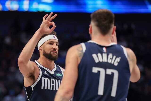 Klay Thompson of the Dallas Mavericks congratulates Luka Doncic on a three-point basket in